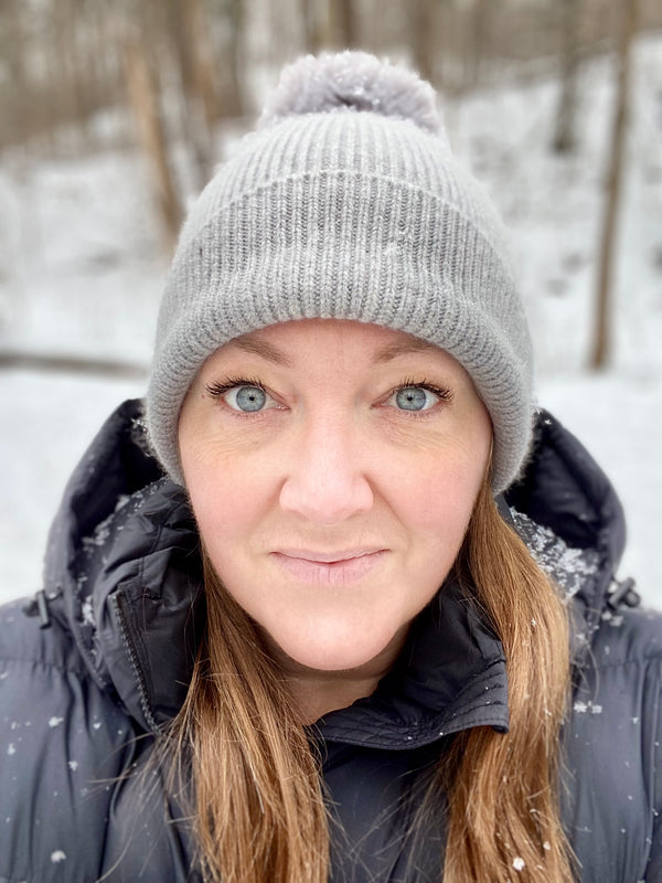 Lesley Daniels wearing winter hat in front of snow
