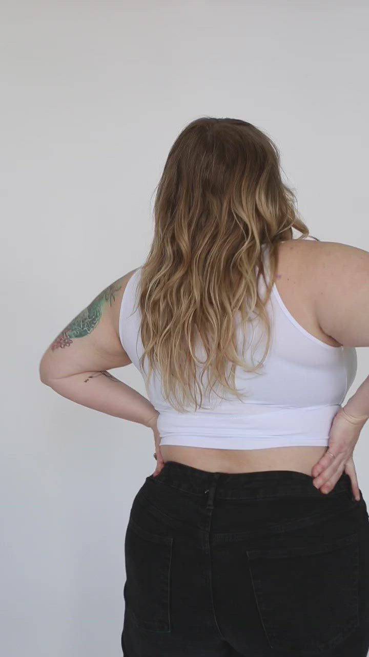 video of a woman show what a white primrose crop tank looks like