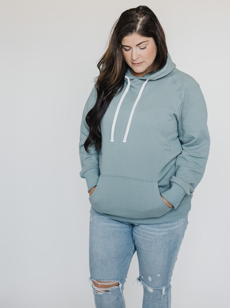 Brunette looking down while wearing the Blondie Classic Forest Hoodie in Trooper Green