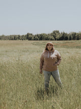 Woman wearing Blondie Classic Forest Hoodie in Stucco Light Brown