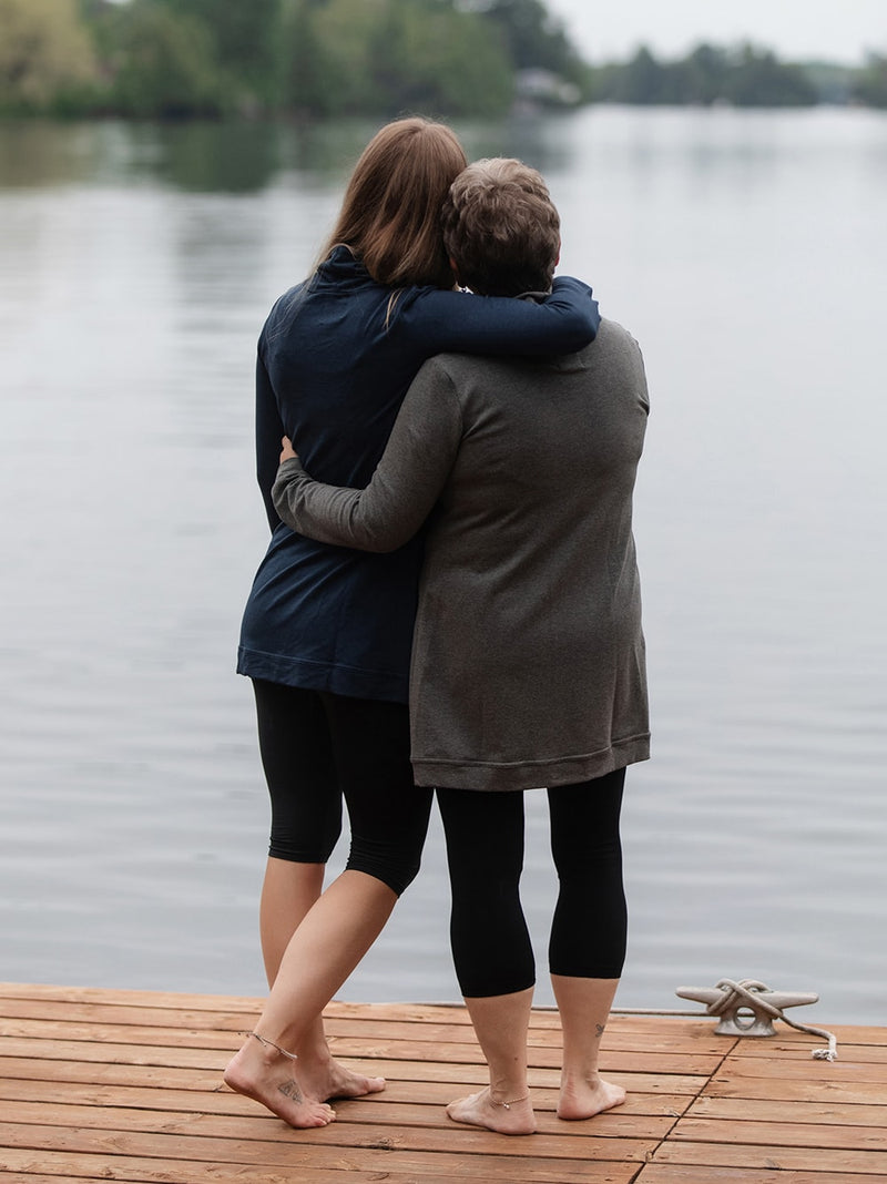 mother and daughter wearing blondie cross front sweaters in navy and charcoal hugging